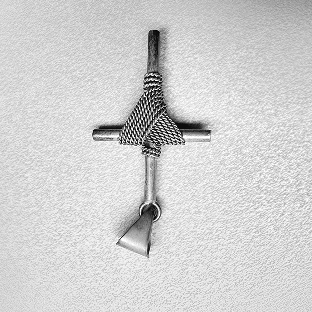 Silver cross pendant with beautiful detail.